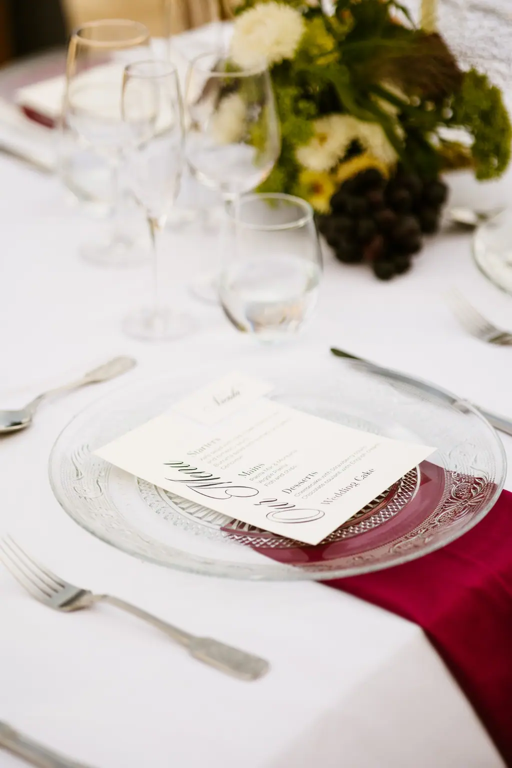 A table set for a private dinner, glassware and a handwritten menu card