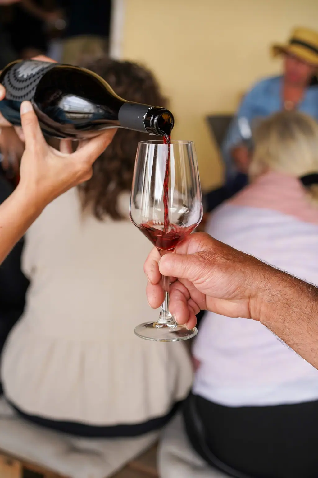 Wine being poured for a guest at a celebration